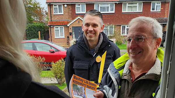 Two members of the Hertsmere Lib Dem team speaking to a resident on the doorstep