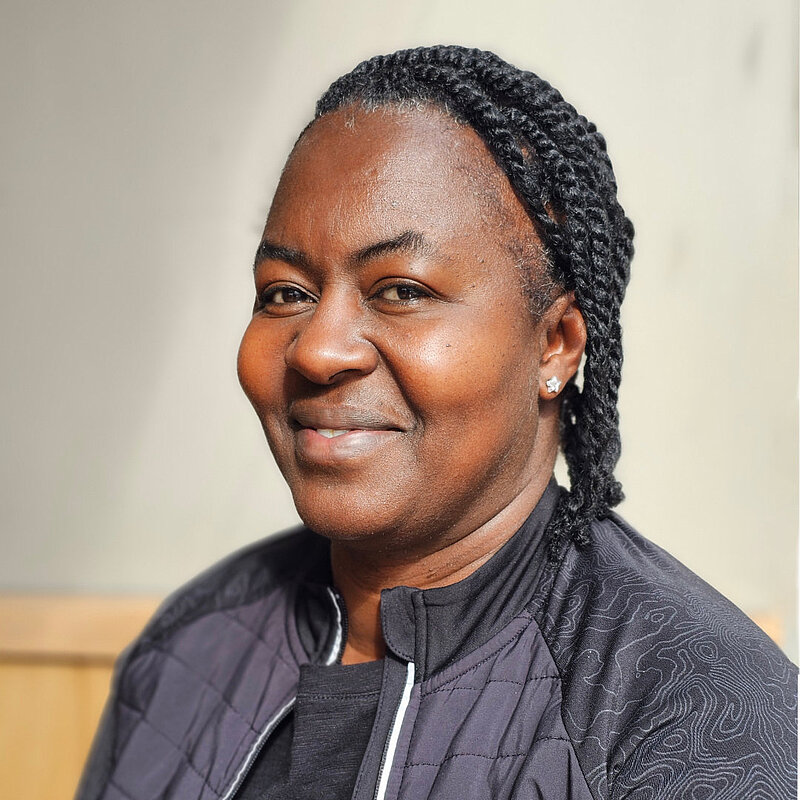 Lisa Griffin in a black jacket with her hair in braids