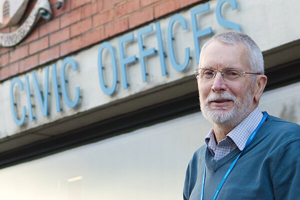 Alan Matthews standing in front of Hertsmere Borough Councils civic offices in Borehamwood