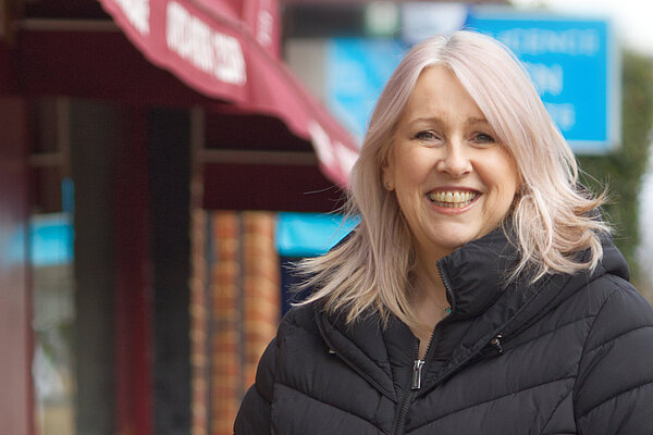 Louise Nicolas stands in front of the shops and restaurant on Park Avenue, Bushey