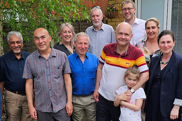 A group of 9 Lib Dem campaigners and a child